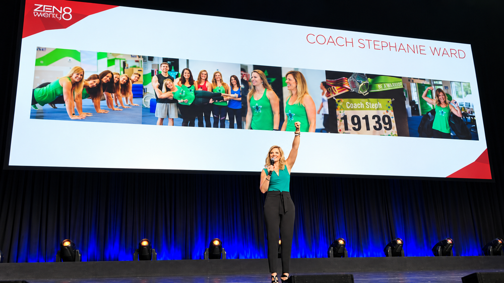 Coach Steph speaking on stage